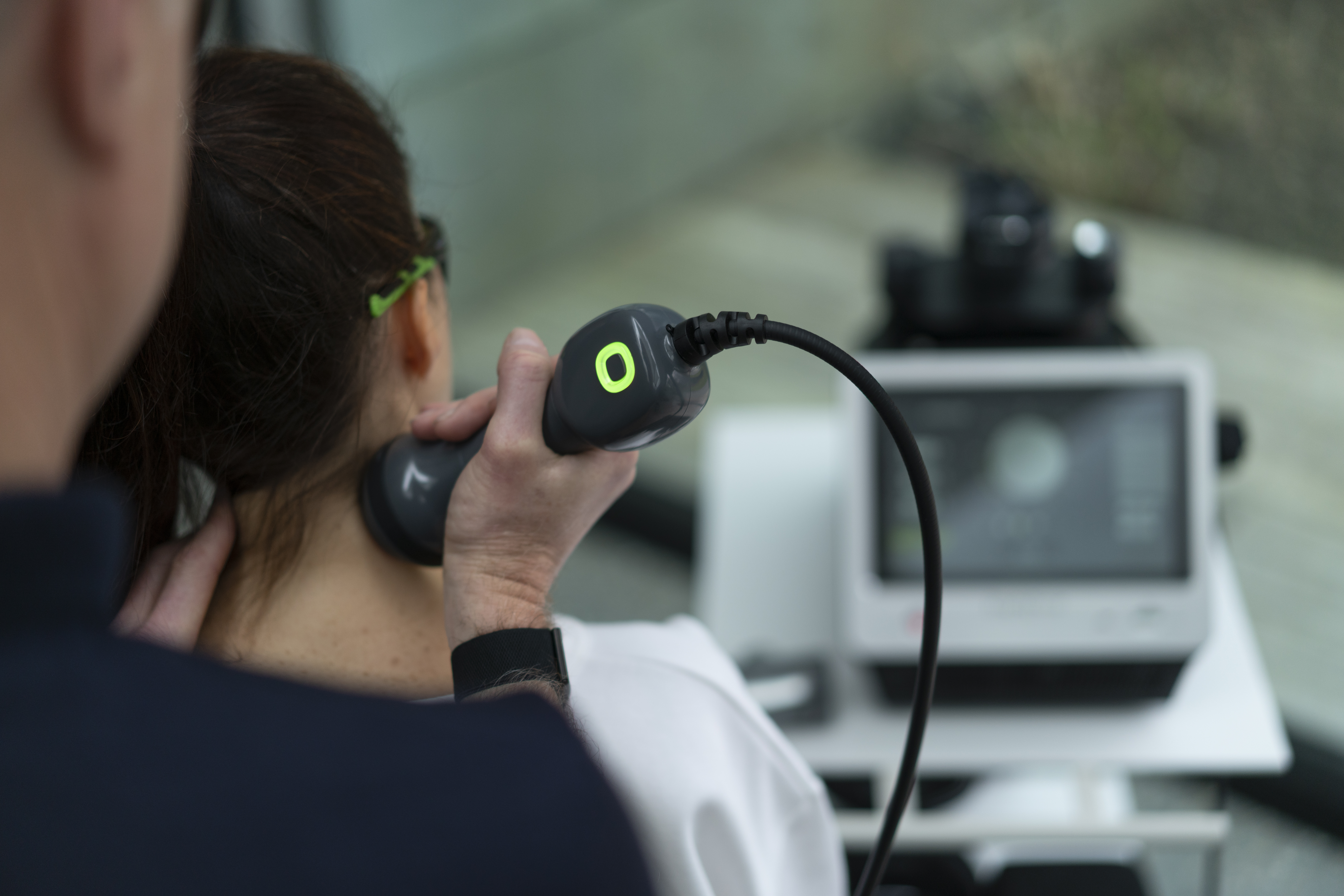 clinician using laser on patient neck