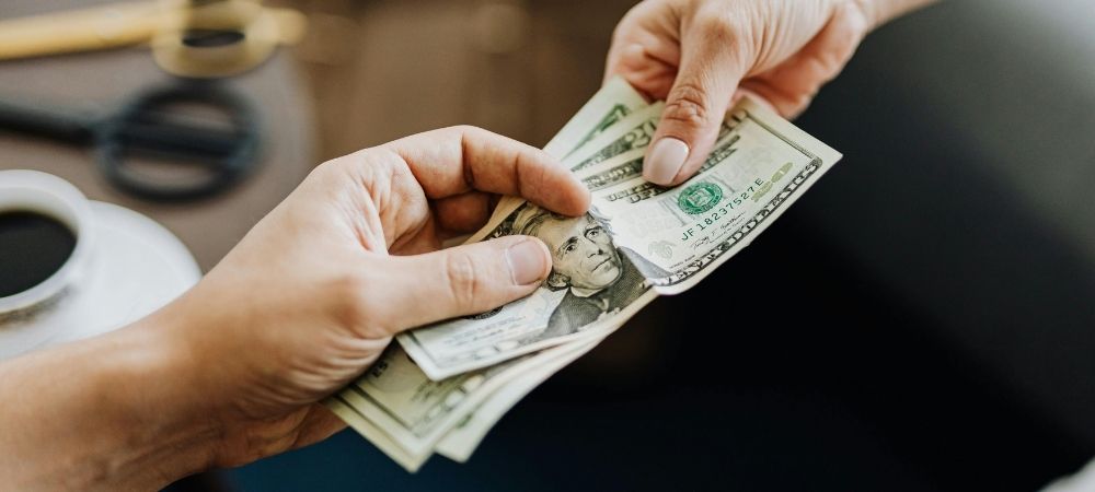 person handing cash to another person