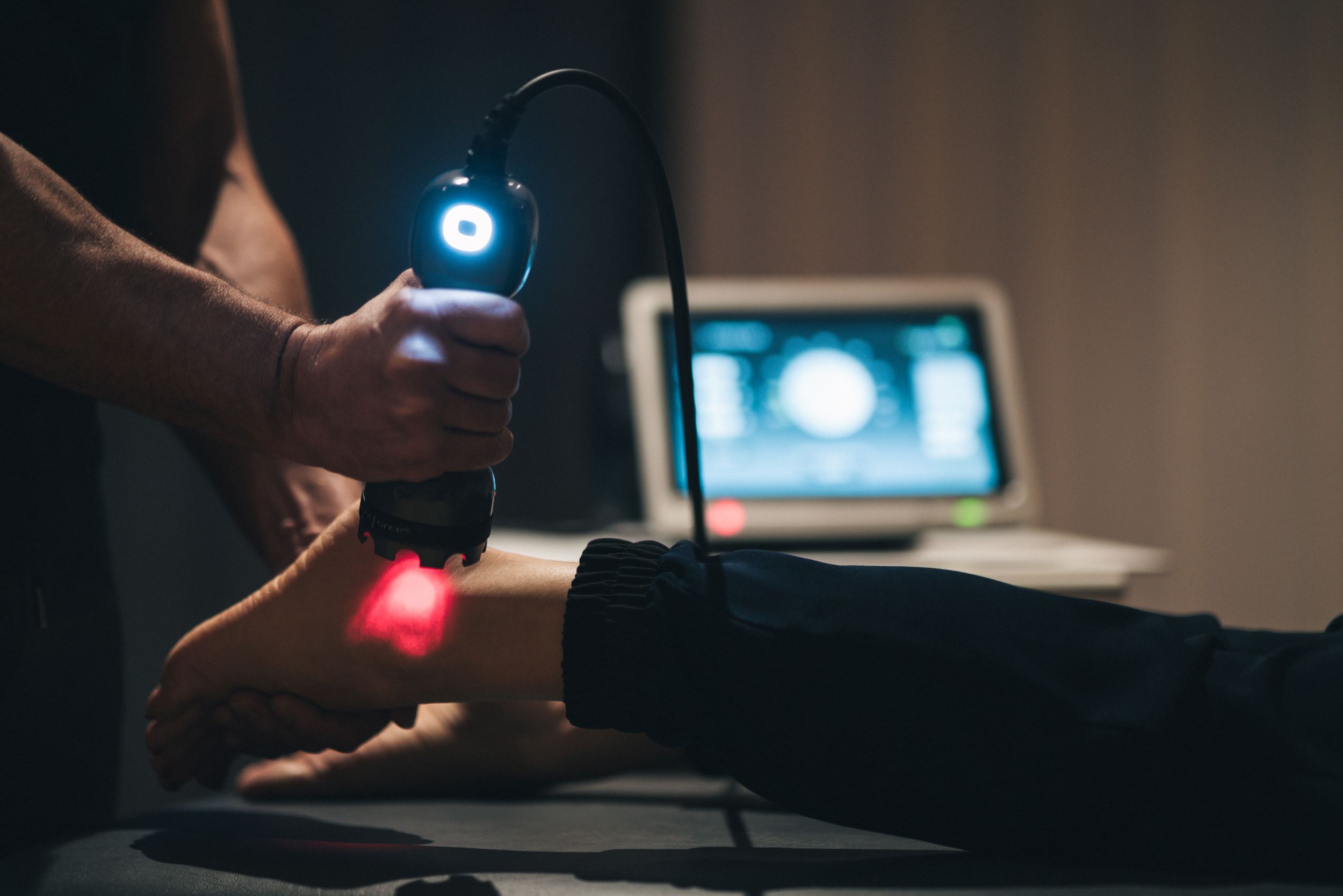 doctor using laser on patient foot