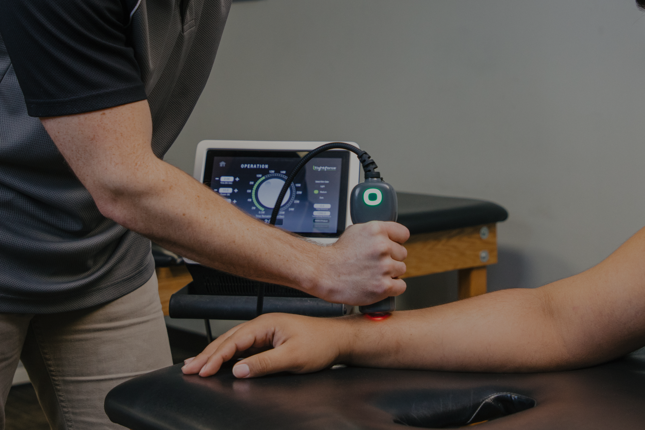 doctor using laser on patient arm