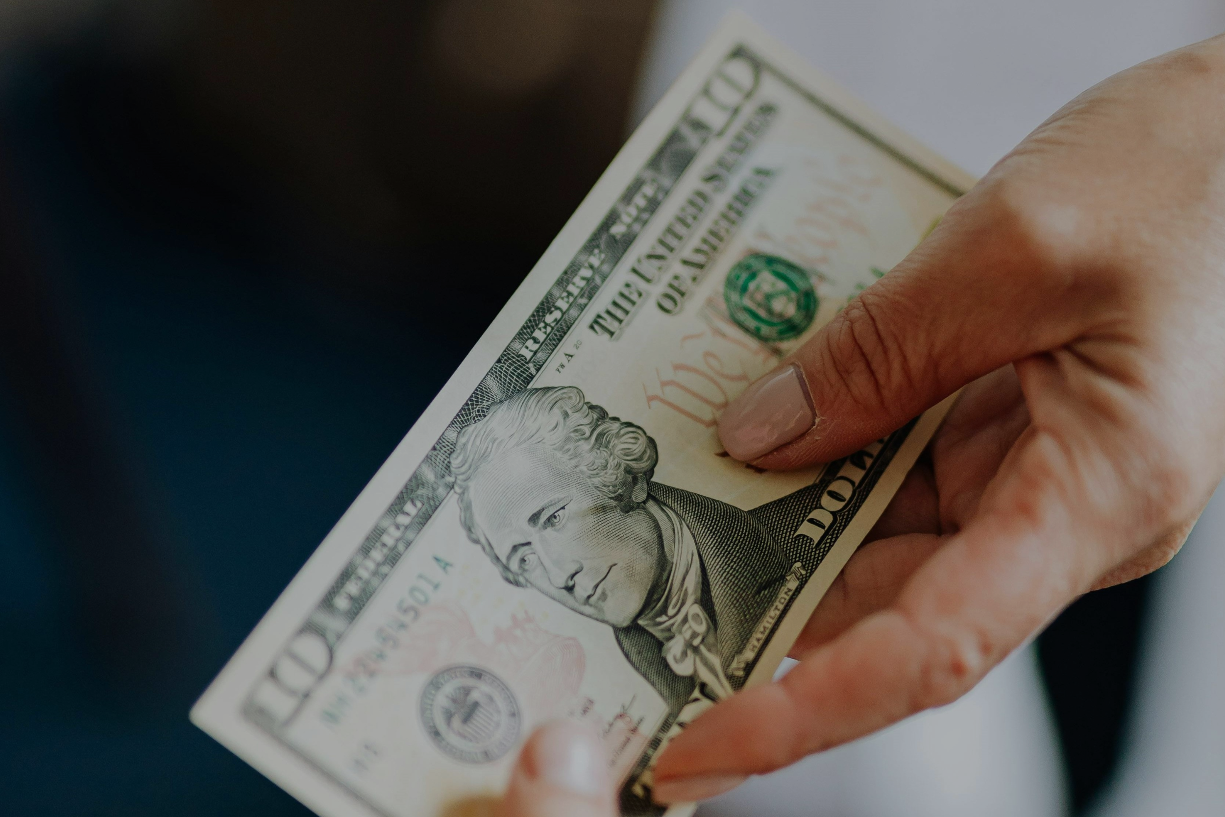 person handing cash to another person