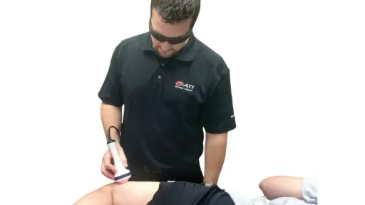 clinician applying laser to leg