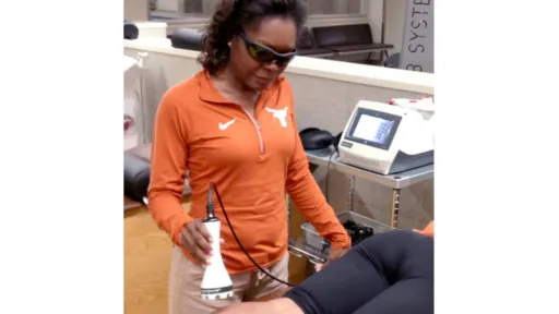 woman using laser on patient leg