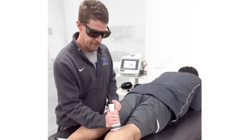 man using laser on back of knee
