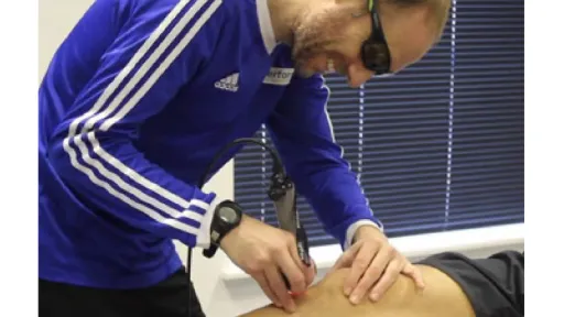 clinician using laser on patient knee