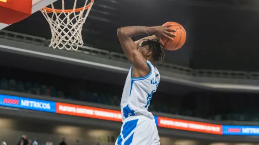 man jumping to shoot a basket