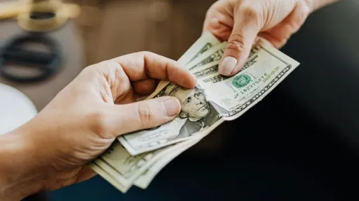 person handing cash to another person