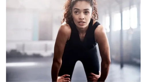 woman resting on knees after workout