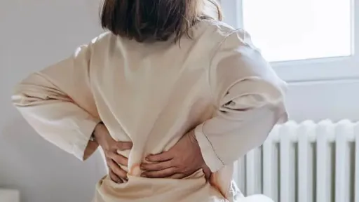 woman in robe with lower back pain