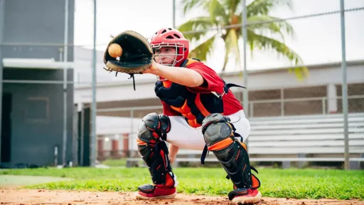 baseball catcher crouched in position at home base