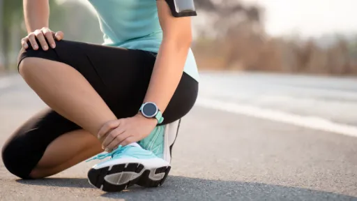 woman in athletic gear with ankle pain