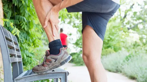 man on nature trail lifting his leg onto bench showing ankle pain