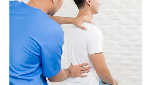 man with back pain, doctor palpating his back