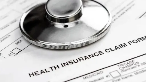 insurance documents with stethoscope on top