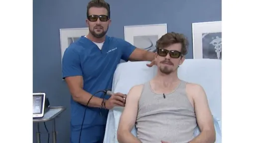 clinician applying laser to patient shoulder