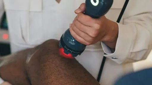 clinician applying laser to knee