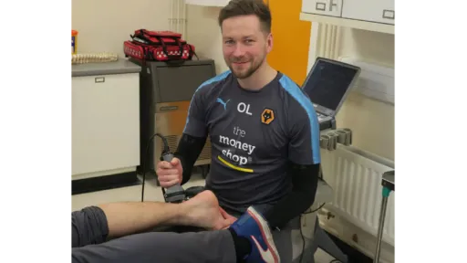 clinician applying laser to patient ankle