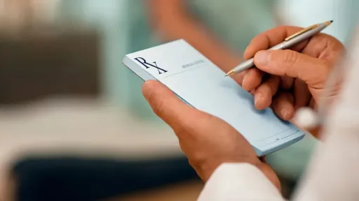 clinician writing on prescription pad