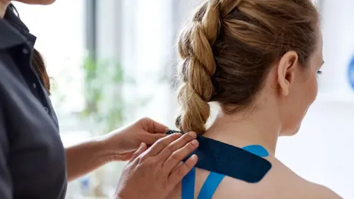doctor applying tape to patient back