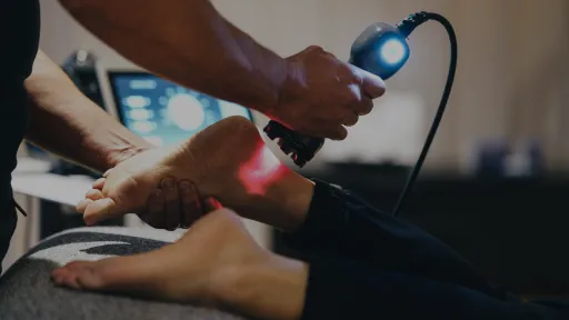 doctor using laser on patient foot
