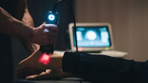 doctor using laser on patient foot