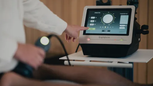 doctor's hand reaching towards laser to change program
