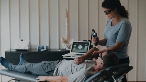doctor treating patient elbow with laser